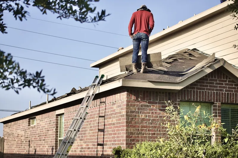Professional roofer working on a residential roof in Reliance